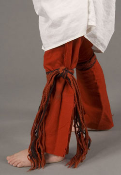 close up of red woolen leggings tied with sashes