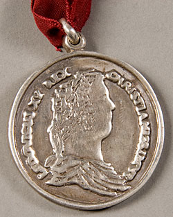 silver medal with face in profile