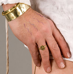 model's hand showing brass ring and bracelets