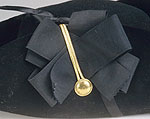 close up detail of ribbon cockade on tricorn hat