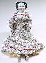doll with porcelain hands, feet and head and a cloth body.
