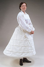 girl model wearing white cotton button-up shirt and large hoop petticoat.