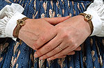 close up of model's hands showing gold bracelets