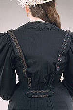 view of the back of the coat showing ribbon trim