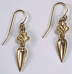 close up of gold, dangling earrings