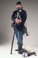 civil war soldier outfitted with all his paraphernalia and holding a musket.