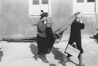 file:/activities/oralhistory/cappics/cohen1945_women, alt: Two German women leaving the Buchenwald concentration camp