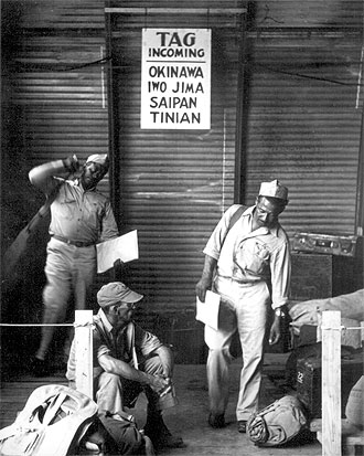 file:/activities/oralhistory/cappics/elliot1939s_okinawa, alt: three african-american soldiers: two standing, one sitting on the ground