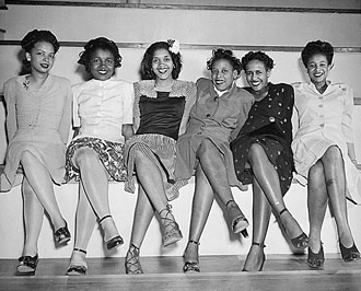 file:/activities/oralhistory/cappics/loving1941_6women, alt: Six young women seated in a line with legs crossed