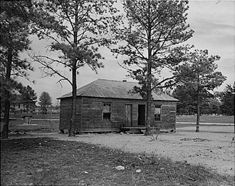 file:/activities/oralhistory/cappics/pryor1934_schoolhouse, alt: B/W photo of one-room schoolhouse
