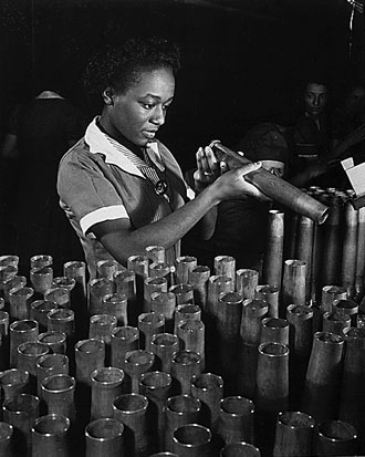 file:/activities/oralhistory/cappics/pryor1941_bertha, alt: woman inspecting metal artillery casings